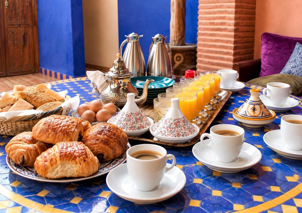 Breakfast table set in the courtyard beneath the brick arch at Riad Hna Ben Saleh